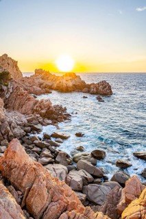 Landscape of the coastline with blue water at Costa Paradiso on a sunny day at sunset, Sardinia,