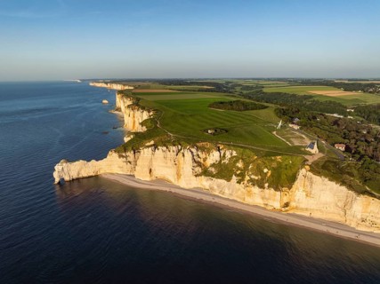 Aerial view of Porte d'Amont rock formation and landmark, Falaise d'Amont in the evening sun,
