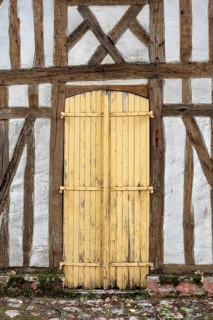 Old, dilapidated wooden door on a half-timbered house in the old town of Troyes, Aube department,