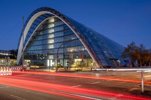 BBCC Berliner Bogen Conference Center at blue hour with light strips of vehicles in the foreground,