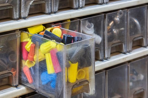Opened plastic parts drawers showing twist on yellow, black, blue and red electrical wire