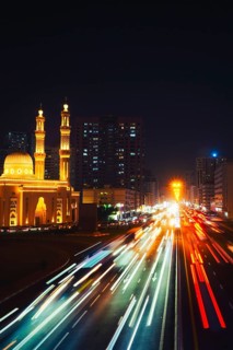 Night long exposure Sharjah Four Khalifas intersection.UAE futuristic architecture. Illuminated
