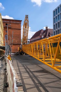 Mobi Hub, heavy construction machine with special technology setting up a crane in the narrow