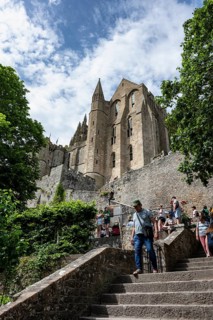 View over the stairway to Le Mont-Saint-Michel Abbey on Rocky Island, monastery island, tourist
