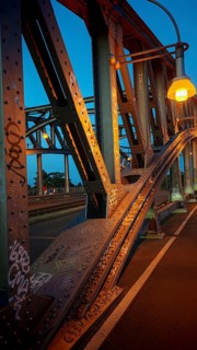 Steel bridge, with graffiti and lanterns in warm evening light, heritage-protected Bösebrücke,