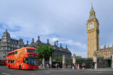 Red double-decker bus in front of Elizabeth Tower with Big Ben, clock tower, Houses of Parliament,