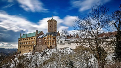 Winter castle landscape with moving clouds in a blue sky over snow-covered scenery, The Wartburg