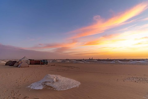 Sunset at a tented camp in the White Desert National Park in the Egyptian part of the Libyan