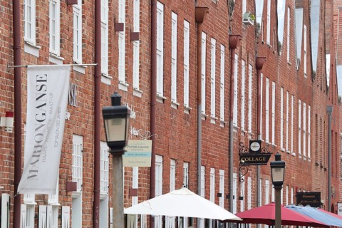 Row of red brick houses with umbrellas, Dutch Quarter, Potsdam, Havelland, Brandenburg, Germany