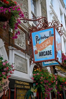 Detailed view of Portobello Garden Arcade entrance sign with floral decoration, Portobello Road,
