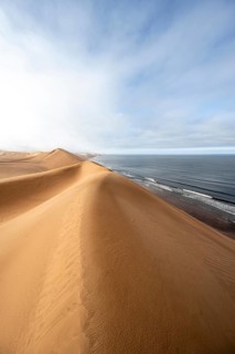 Sand dunes and sea in morning light, Atlantic coast and Namib desert, impressive desert landscape,