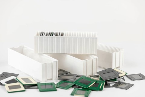 White slide holders next to slides against white background