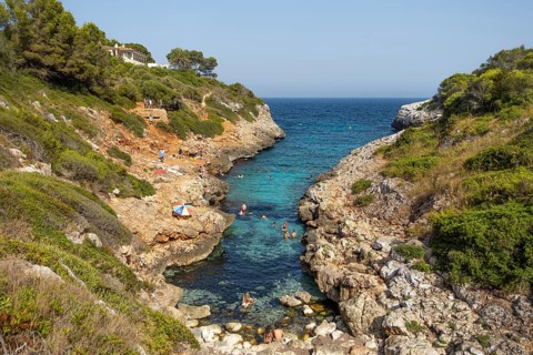 People bathe in Cala Muta Bay in Majorca, Cala Muta, Porto Cristo, Majorca, Spain
