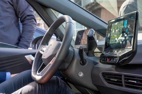 Modern car interior view with steering wheel and integrated navigation system on display, Deer,