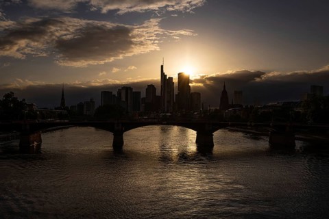 The sun sets behind Frankfurt's banking skyline, Frankfurt am Main, Hesse, Germany