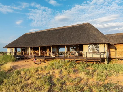 The main building of the Ta Shebube Rooiputs Lodge in the Kalahari Desert during the rainy season