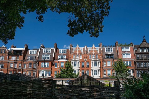 Victorian townhouses on Royal Hospital Road, woven fence and historic greenhouse, Chelsea Physic
