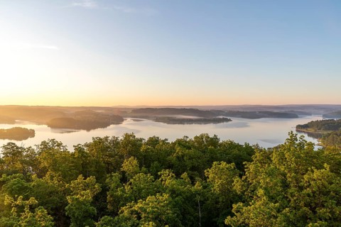 View from Julius-Mosen Tower of Pöhl Reservoir at sunrise with morning fog, Vogtland, Saxony,