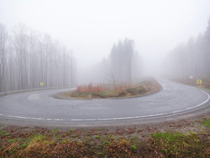 Sweeping a mountain pass in fog, Maramures, Romania