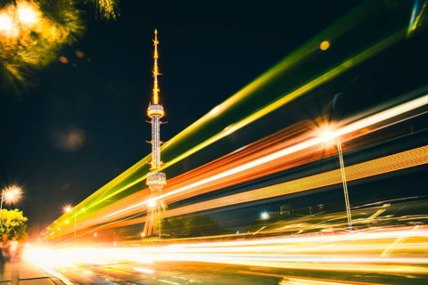 Tashkent soviet architecture TV tower Uzbekistan. Time lapse night city traffic light trails