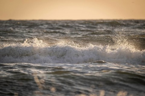 Surf, breaking wave against light, Sortebærdalen Strand, Houvig, North Sea, Denmark