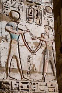 Close up details of ancient Egyptian history shown in reliefs and hieroglyphs inside Medinat Habu,