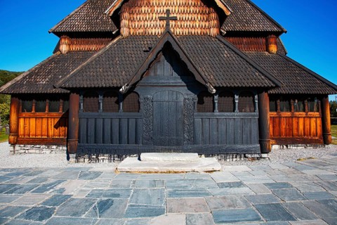 Detailed view of the wooden façade of a church with shingle roof under a clear sky, Heddal Stave