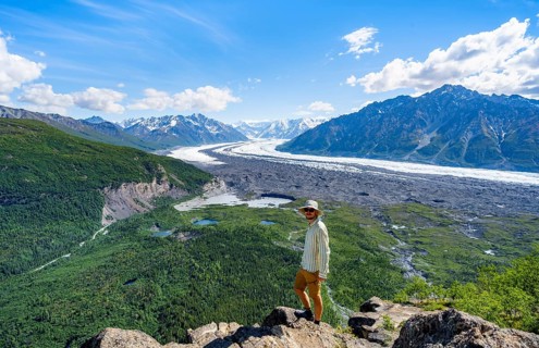Young man enjoying the view, view of impressive mountain landscape with Matanuska glacier and