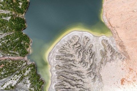 Lake with sandbank and dead trees, crater rim of chaiten volcano, aerial view, Patagonia, Chile