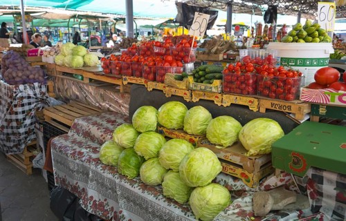 Market stand with fresh vegetables such as cabbage, tomatoes and cucumbers Central Market, Piata