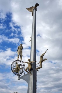 Close-up of the distinctive harbor sculpture of Meersburg with several figures on a vertical metal