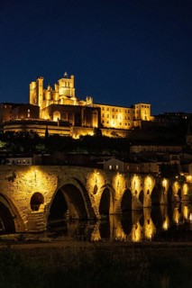 Castle and bridge in evening light with lights, Béziers, Fra