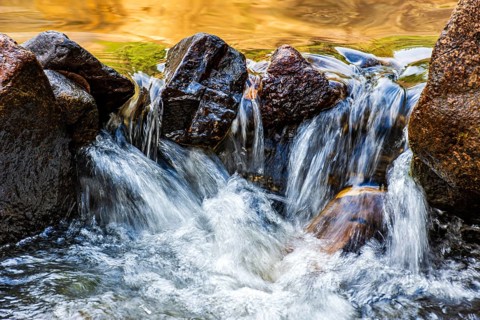 Water flowing between rocks in a small stream, Minas Gerais, Brazil