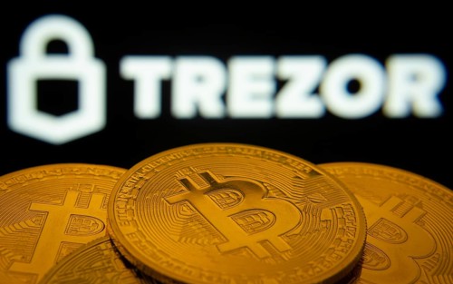 Dhaka, Bangladesh- 30 Sep 2025: Close-up of Bitcoin coins with the Trezor logo visible on a screen