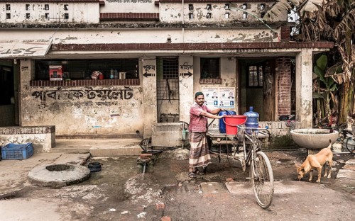 Man with rickshaw fetching water, Dhaka, Bangladesh