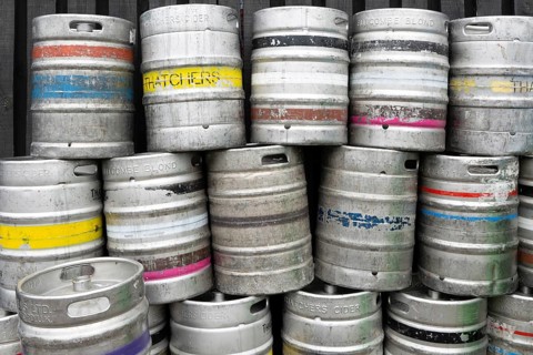 Pile of empty steel beer and cider kegs, UK