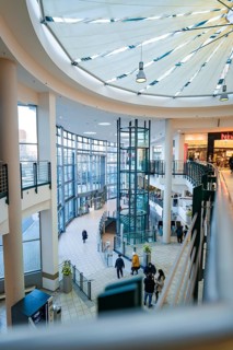 Open, multi-storey shopping centre with modern glass roof and bright premises, Sterncenter