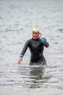 Sportswoman, swimmer comes out of the water after the swimming stage, Tegernsee Triathlon,