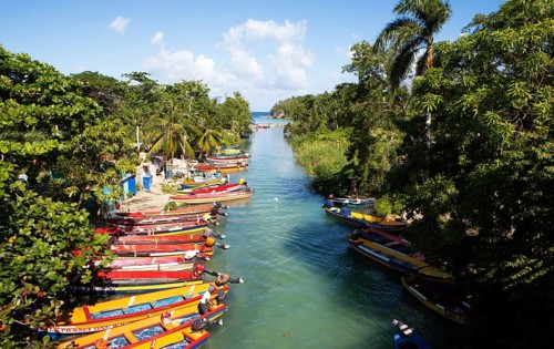 Colourful fishing boats on the banks of the White River or river at Ochos Rios, Saint Ann Parish