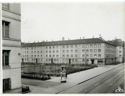 Multi-storey residential buildings along a street, early 20th century, quiet city atmosphere