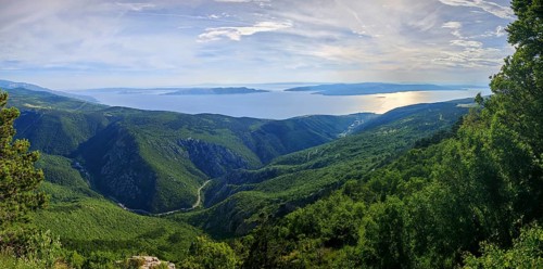 Panoramic view over green mountains of Kvarner Gulf Bay with sea in the background, Croatia
