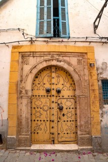 Detailed yellow ornate design of a typical door in the Medina of Tunis, a UNESCO designated quarter