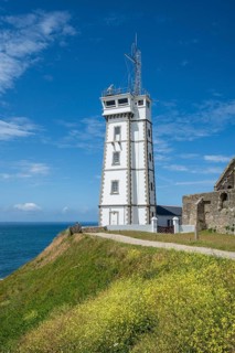 View of the distinctive white signal building, Sémaphore on the rocky cliffs. The coastal