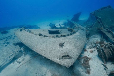 Large wreck, bow of a ship lying abandoned on the sandy seabed, meteor wreck dive site, Russian