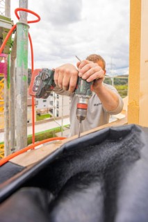 A craftsman drills wood on a construction site, residential renovation, Nagold, Calw district,