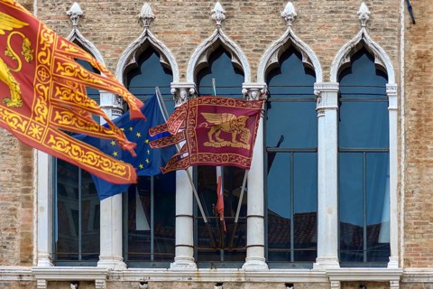 Waving flags of Europe and the Republic of Venice at Palazzo Zaguri, Venice, Venice, Italy