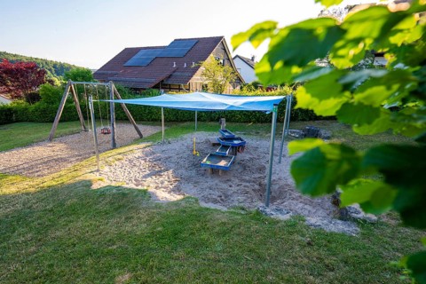 A playground with awning over sandy areas in a quiet residential area, Playgrounds Gechingen, Calw