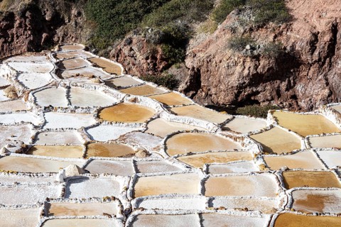 Individual terraces of the Salinas de Maras, salt terraces on a mountainside for salt production
