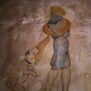 A mural depicts a stylish woman with a fox terrier, surrounded by a warm-toned, second-hand retro