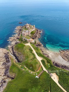 Aerial view of the historic rock castle Fort la slat, Château de la Roche Goyon on a rocky headland